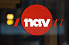 Rød NAV-logo på glassfasade ved arbeidslivssenteret i Oslo.