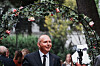 Mads Nygaard i dress under en blomsterbue ved Aschehougs hagefest i Oslo.