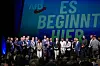 AfD-ledere og partimedlemmer står på en scene foran teksten «Es beginnt hier».