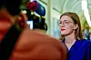 Marie Sneve Martinussen i blå skjorte etter finanstalen i Stortinget, med en fotograf i uskarp forgrunn.